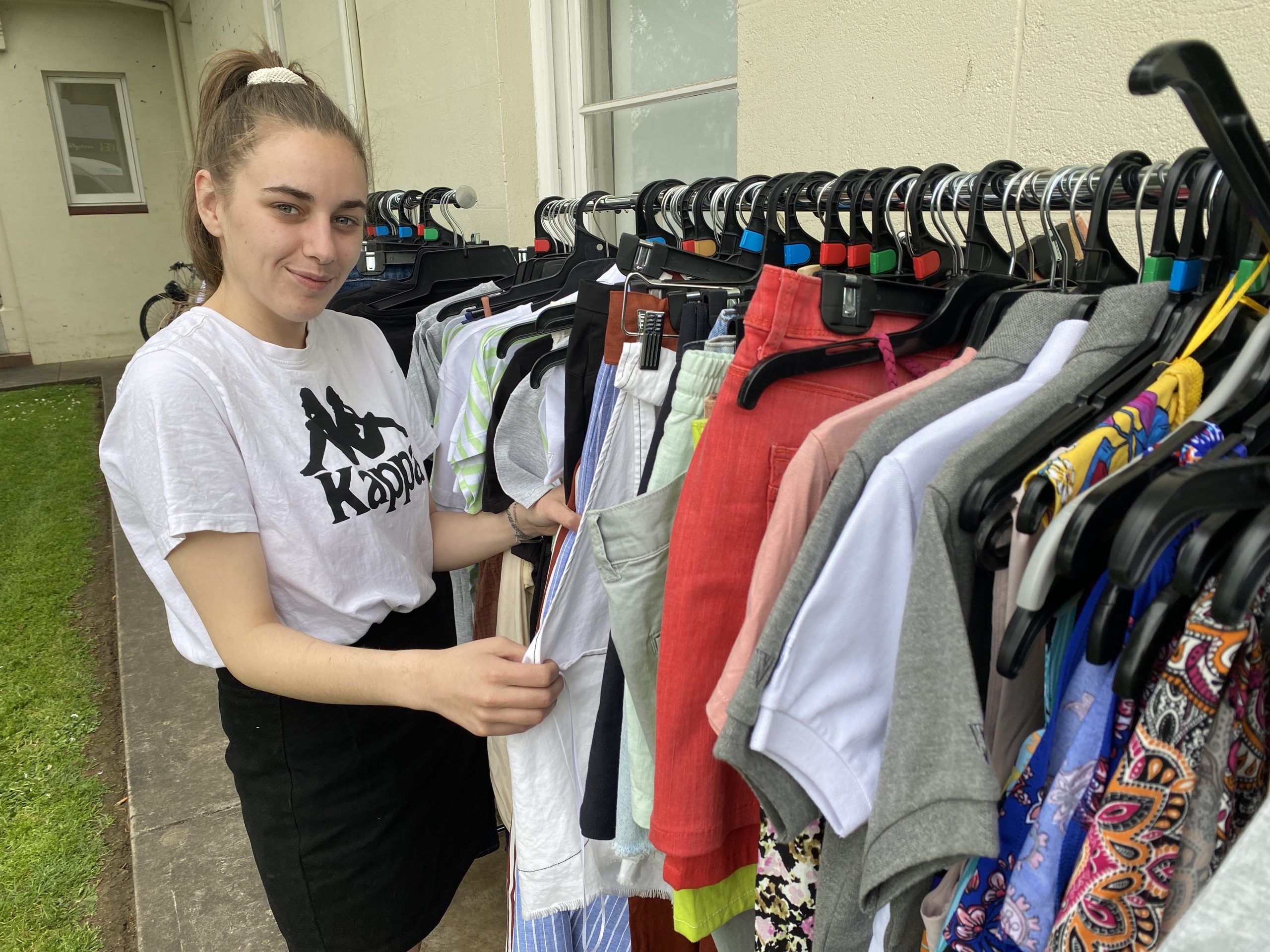 PLENTY OF OPTIONS: Kym looks through the donated clothing on offer thanks to the visit by the Thread Together mobile clothing van.