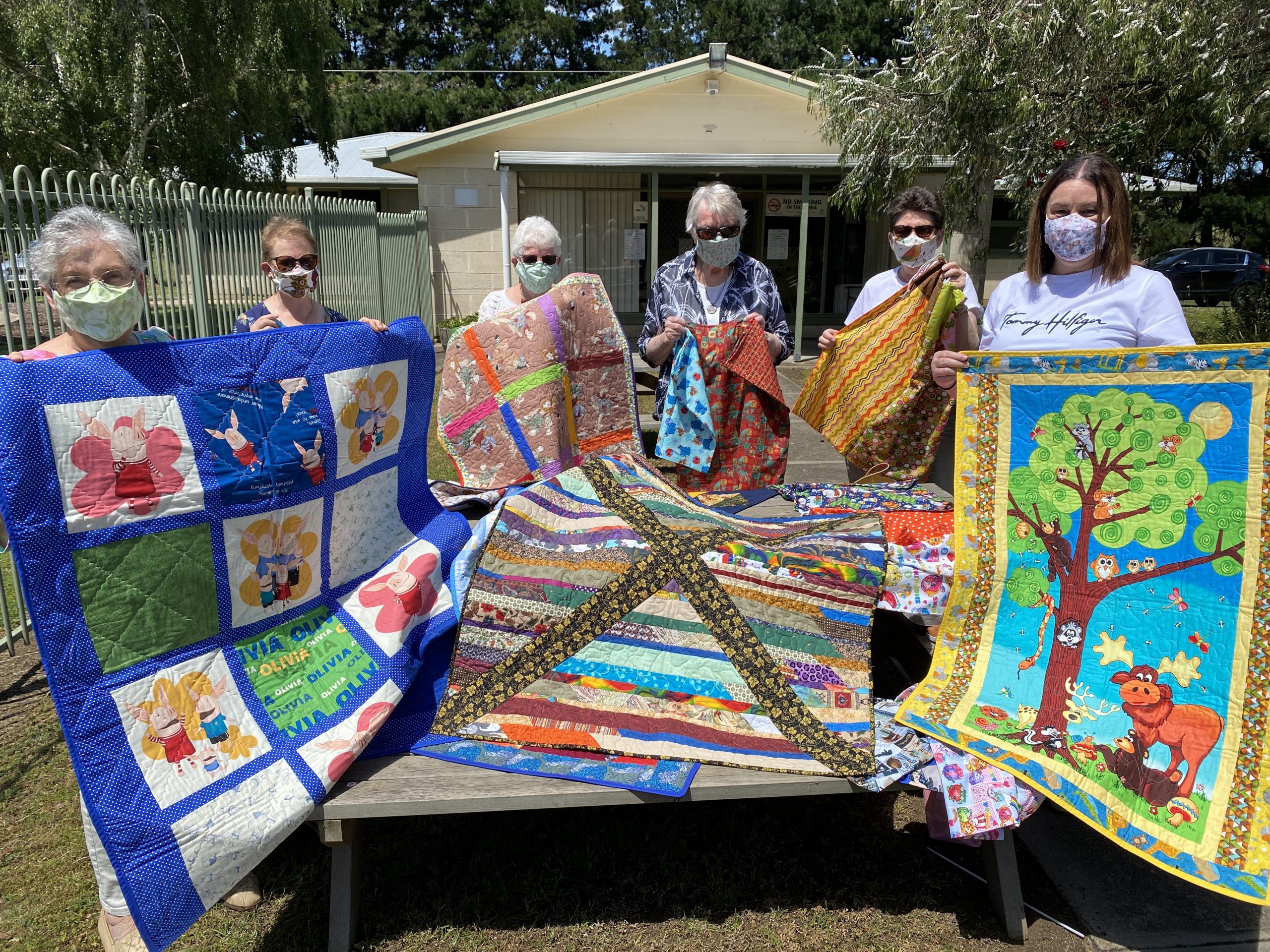 TREASURED SUPPORT: ac.care foster care manager Sherri Winter (right) with members of the Pine Tree Quilters during the recent handover of 17 hand-made quilts to be donated to children in foster care on the Limestone Coast, along with 139 Santa sacks and 10 small drawstring bags to brighten distribution of donated goods to vulnerable people for Christmas.