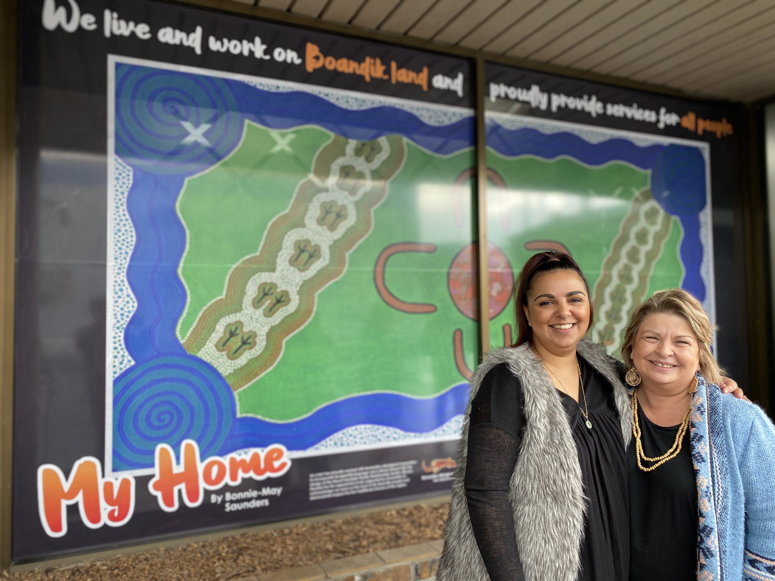 BOLD STATEMENT: Boandik artist Bonnie-May Saunders and ac.care Limestone Coast Reconciliation In Action group chairperson Lynette Heiming celebrate installation of the mural at ac.care’s Mount Gambier Family Relationship Centre.