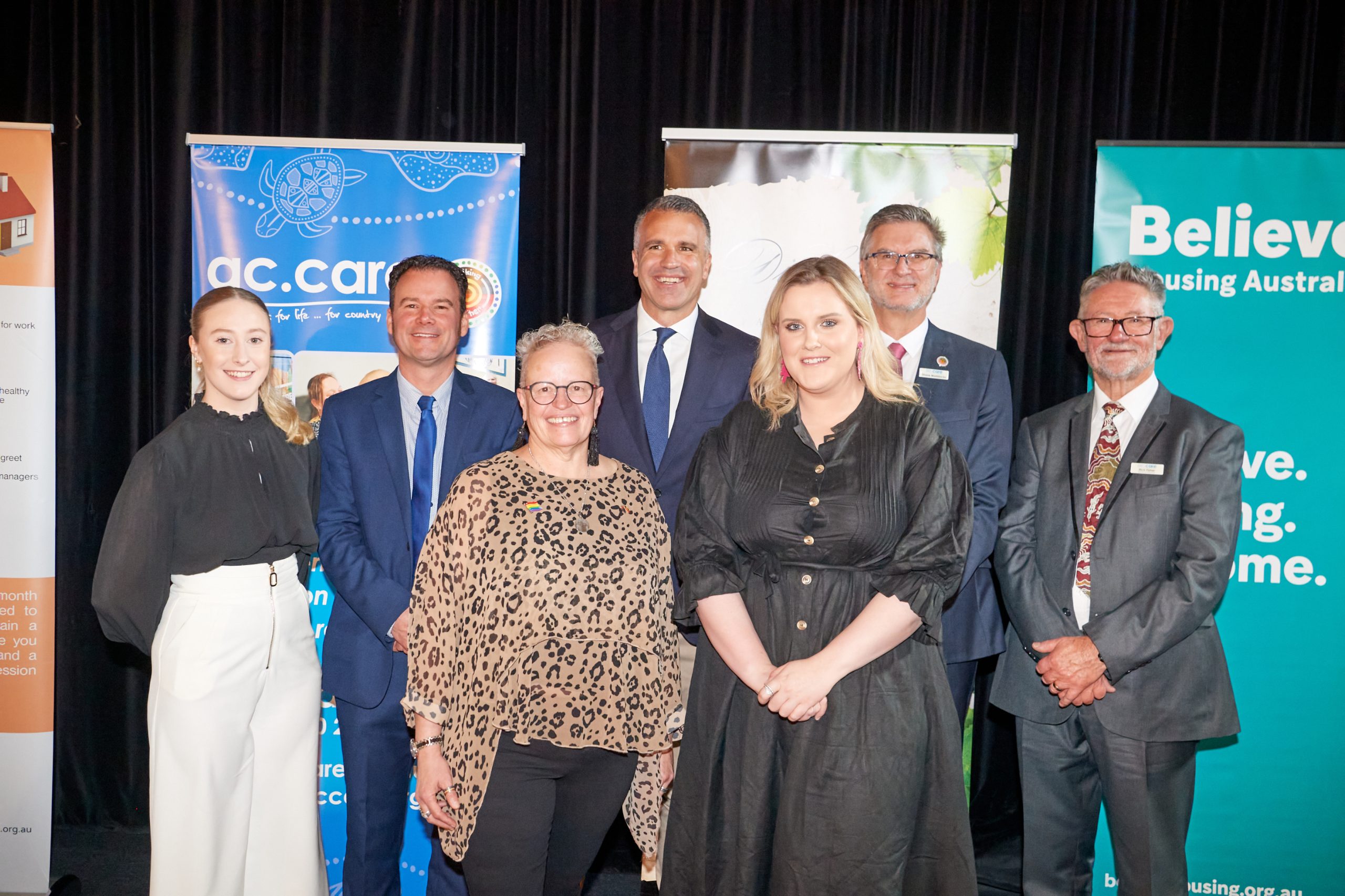 UNITED: Emcee Di Ind (front left) and social media volunteer Caitlin Kennedy with videographer Teagan Hill (back left), event coordinator Jason Wallace, Premier Peter Malinauskas, ac.care chief executive officer Shane Maddocks and ac.care chairperson Rick Fisher at the 2023 Limestone Coast Support Homeless People Luncheon.