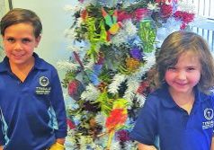 WORKING TOGETHER: Daniel and Alexis at the Tyndale Christian School enjoyed decorating a Christmas tree with other children as part of the ac.care Murraylands Communities for Children initiative.
